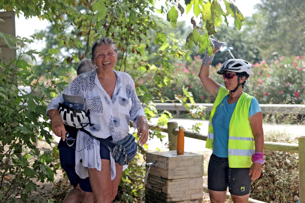 Cyclists stopping at a countryside honesty stall to pick up local snacks