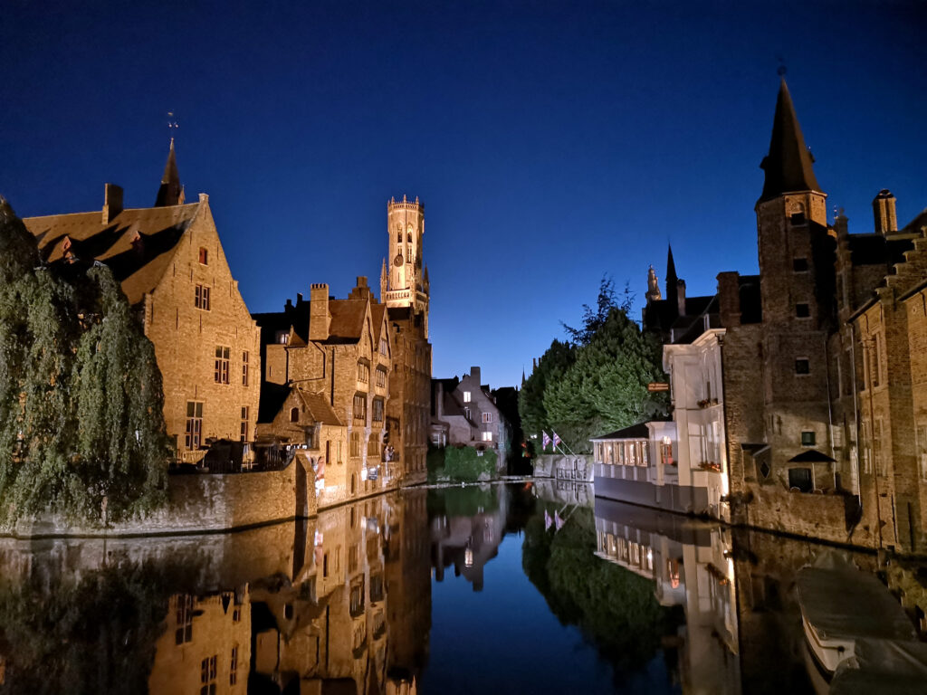 Famous spot in Bruges with buildings overlooking the canal at night