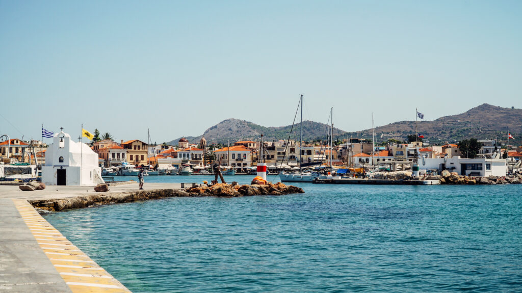 Colourful harbour with whitewashed church, Greek islands cycling and sailing tour