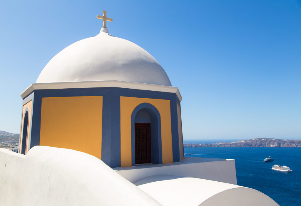 White and yellow domed chapel with sea view, Santorini, Cyclades Greece