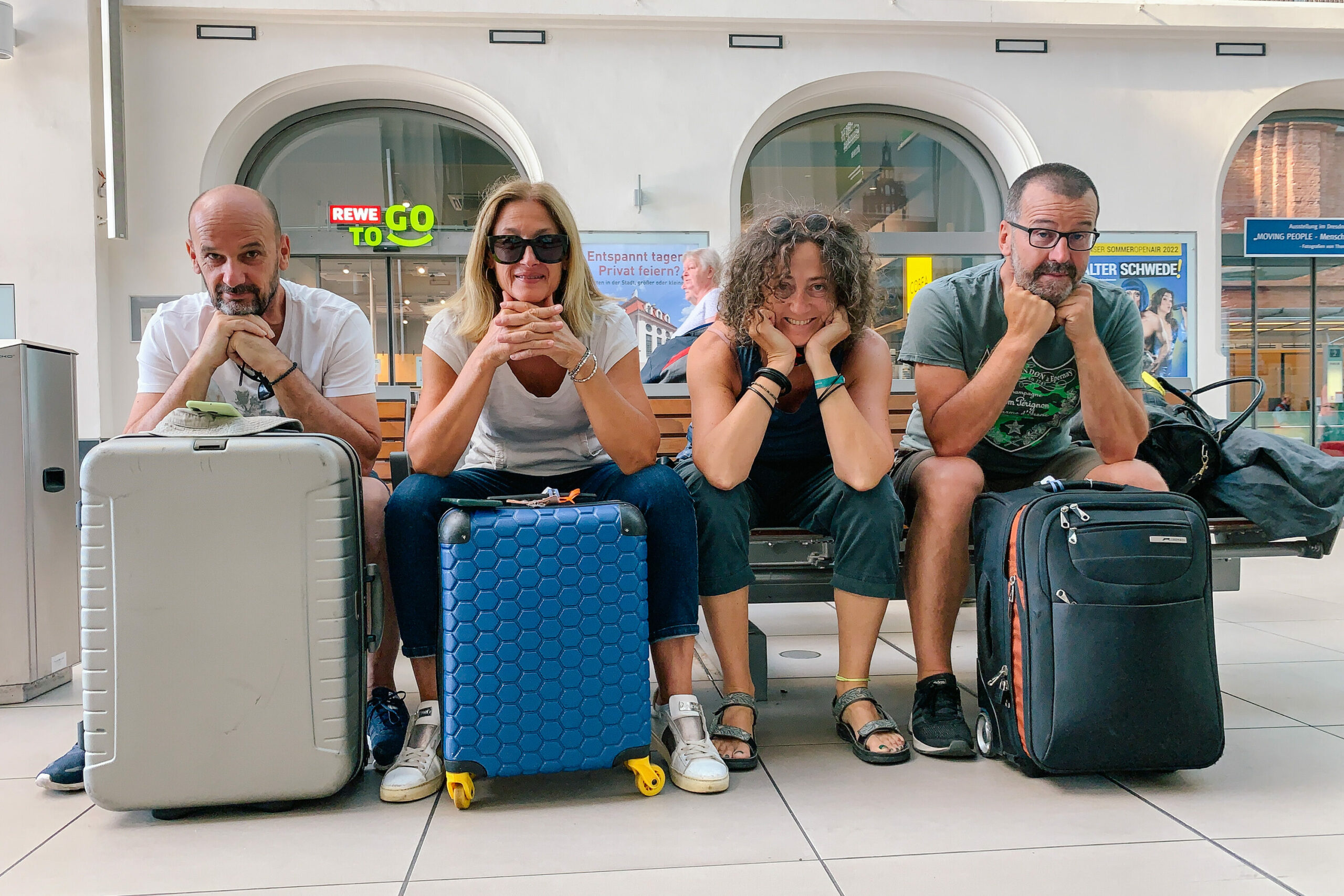 Group of friends waiting with luggage before starting a self-guided bike tour